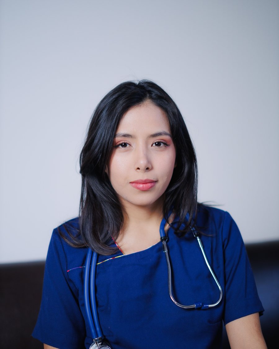 A nurse in navy scrubs with a stethoscope.